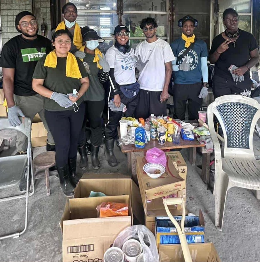 Cleanup volunteers in Hualien, Taiwan gathered indoors near boxes and supplies